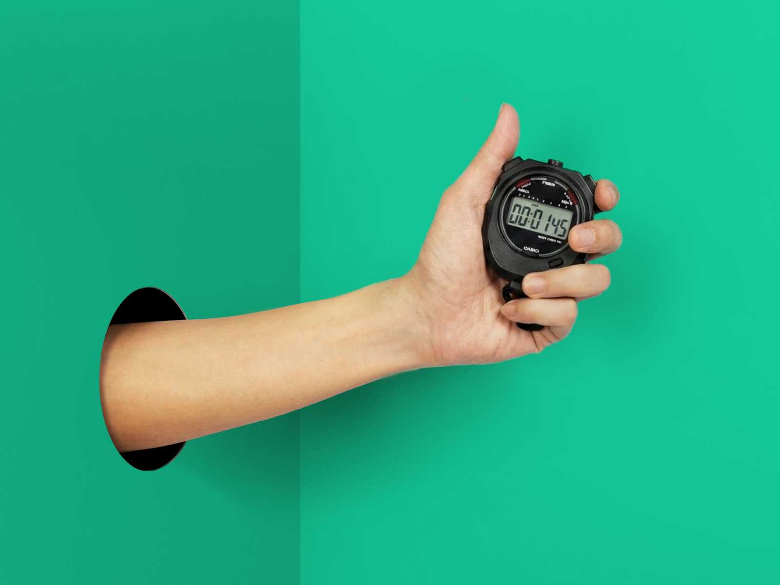 Hand with a stopwatch showing how fast user testing with Userbrain is